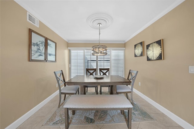 tiled dining area with crown molding and a notable chandelier