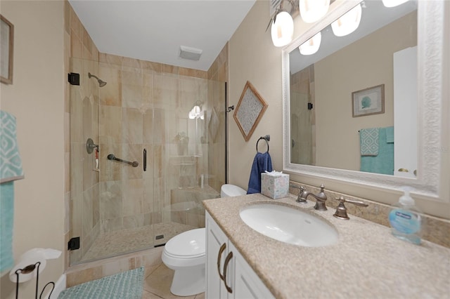 bathroom with a shower with door, toilet, tile flooring, and large vanity