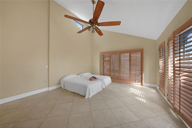 unfurnished bedroom featuring high vaulted ceiling, ceiling fan, and light tile flooring