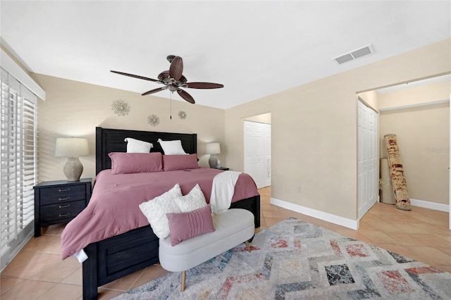 bedroom featuring a closet, ceiling fan, and light tile floors