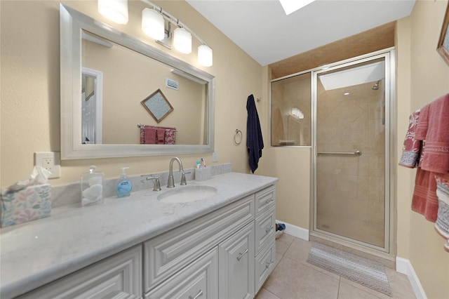 bathroom featuring walk in shower, tile floors, and oversized vanity