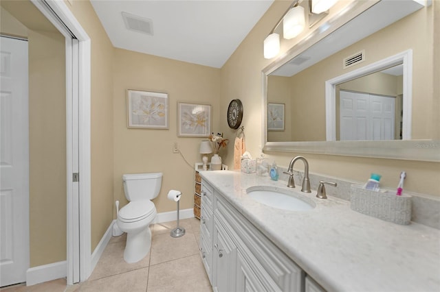 bathroom featuring vanity, tile floors, and toilet