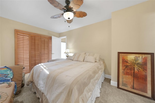 carpeted bedroom featuring a closet and ceiling fan