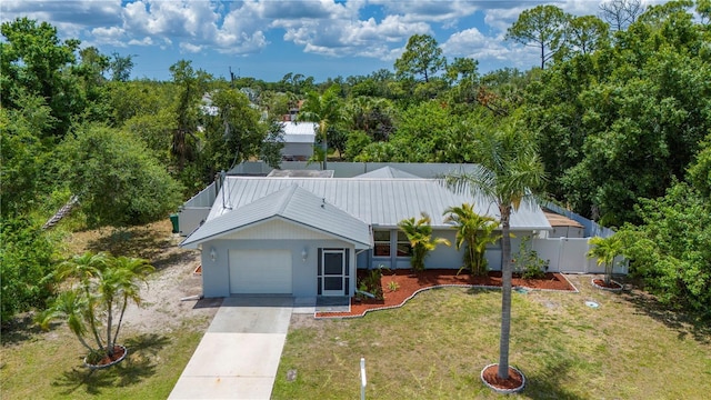 view of front of home with a front lawn and a garage