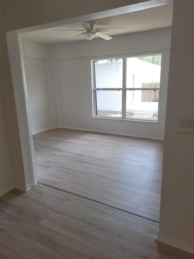 unfurnished room with ceiling fan and hardwood / wood-style flooring