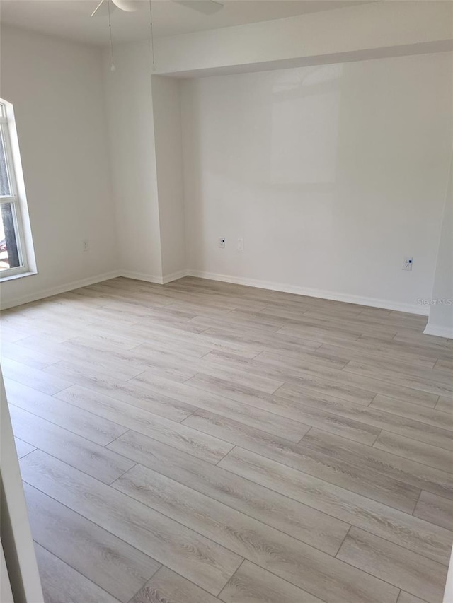 unfurnished room with light hardwood / wood-style floors and ceiling fan