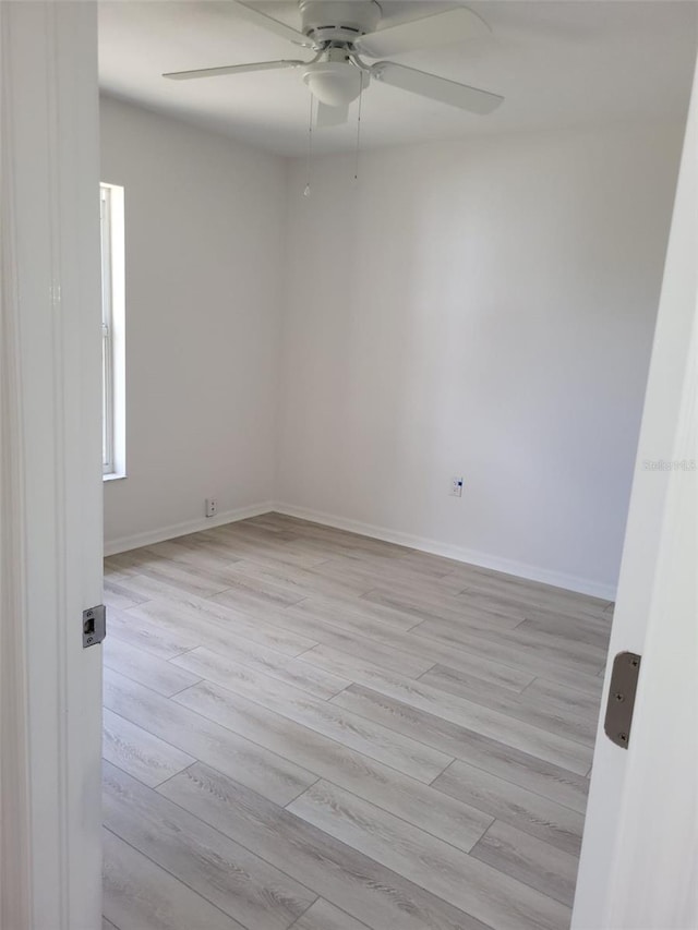 spare room featuring light hardwood / wood-style flooring and ceiling fan