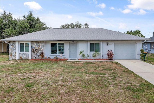 ranch-style home featuring a garage and a front lawn