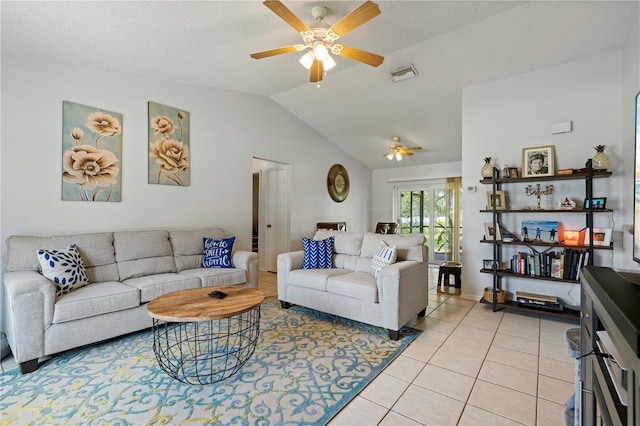 living room with lofted ceiling, ceiling fan, a textured ceiling, and light tile flooring