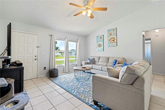 tiled living room with a textured ceiling, ceiling fan, and vaulted ceiling