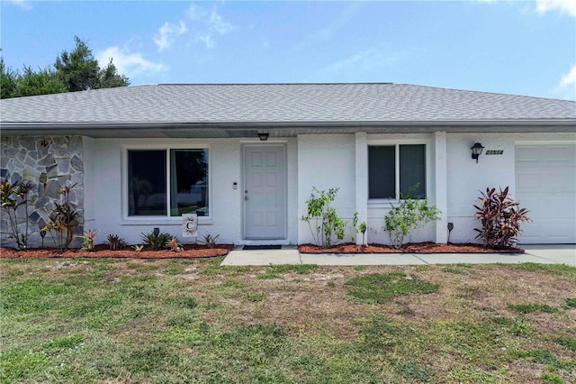 view of front of home with a front lawn and a garage