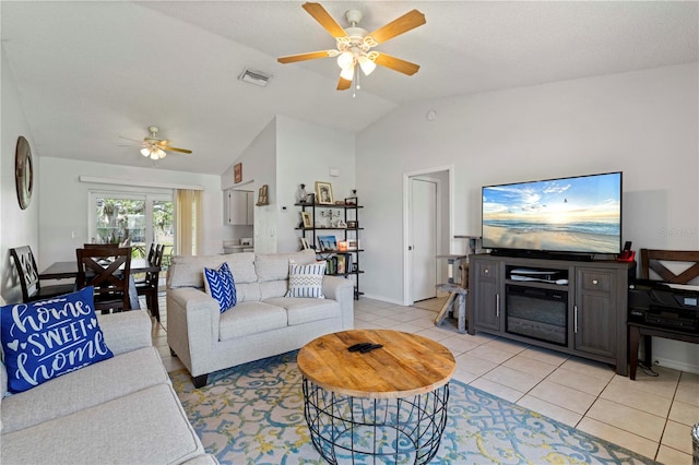 tiled living room with lofted ceiling and ceiling fan