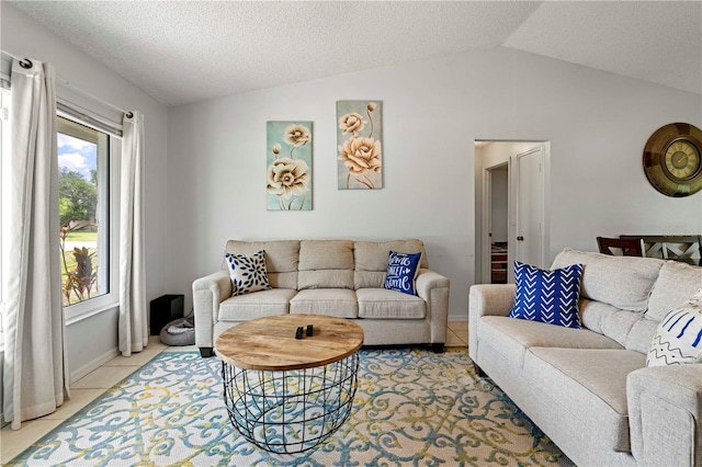 tiled living room featuring lofted ceiling and a textured ceiling