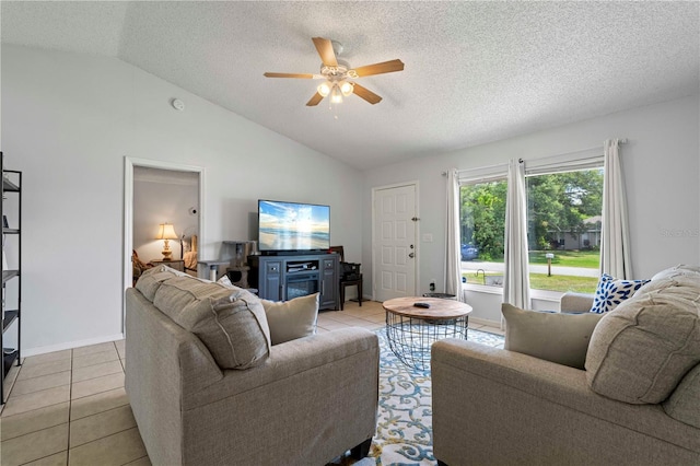 living room with lofted ceiling, ceiling fan, and light tile flooring