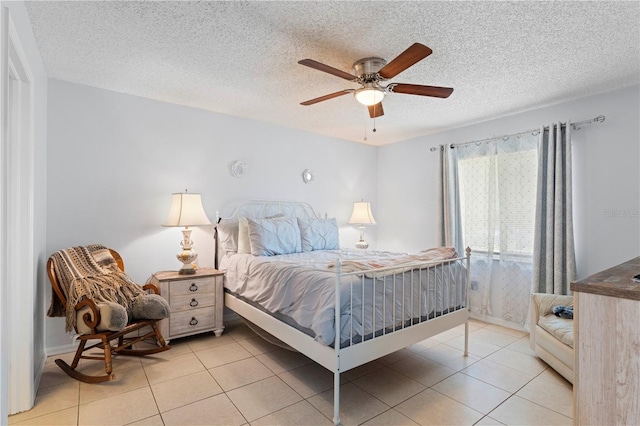 bedroom with a textured ceiling, ceiling fan, and light tile floors