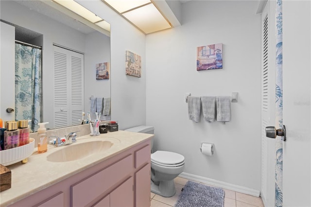 bathroom with tile floors, vanity, and toilet