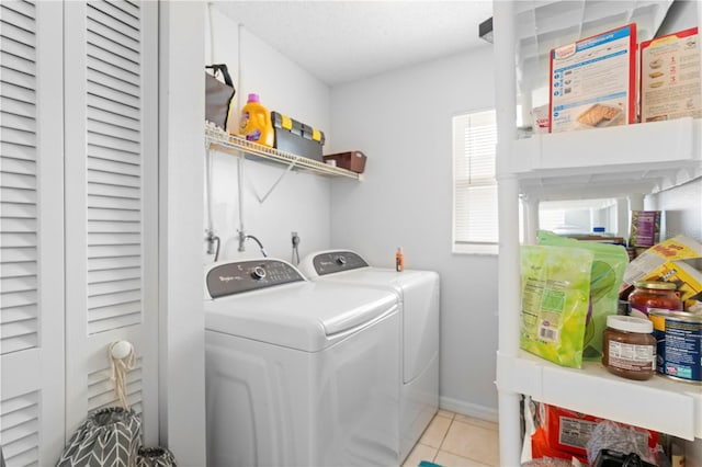 clothes washing area with washer and clothes dryer, hookup for an electric dryer, and light tile flooring