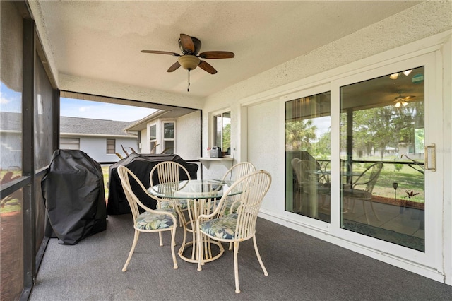 sunroom / solarium featuring a healthy amount of sunlight and ceiling fan