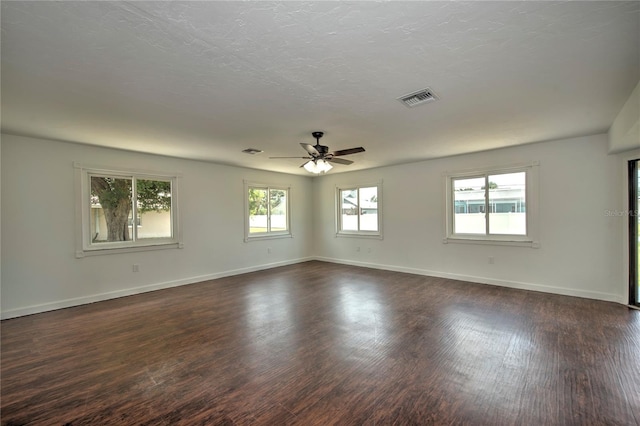 empty room featuring dark hardwood / wood-style flooring and ceiling fan