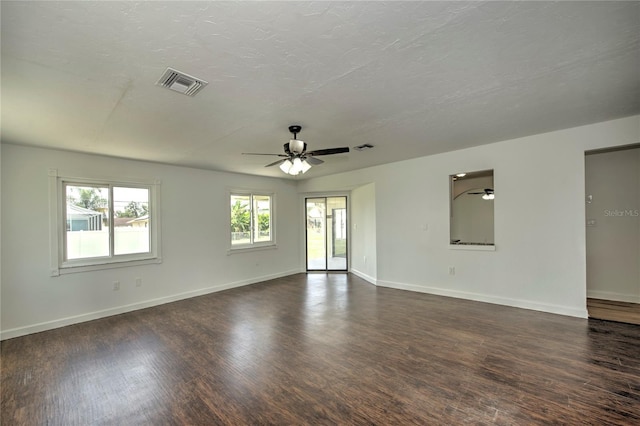 unfurnished room featuring ceiling fan and dark wood-type flooring