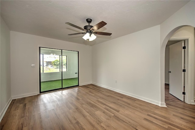 spare room featuring hardwood / wood-style floors and ceiling fan