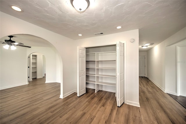 interior space with dark hardwood / wood-style flooring and ceiling fan