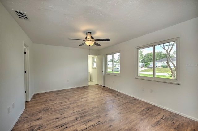 spare room featuring wood-type flooring and ceiling fan