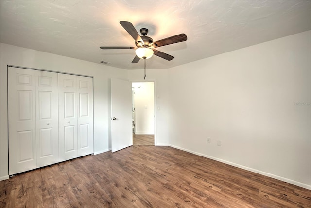 unfurnished bedroom featuring a closet, ceiling fan, and hardwood / wood-style flooring