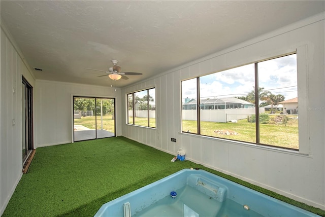 interior space with ceiling fan