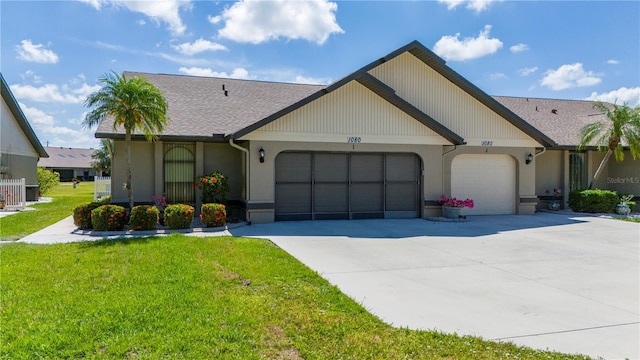 single story home featuring a garage and a front lawn