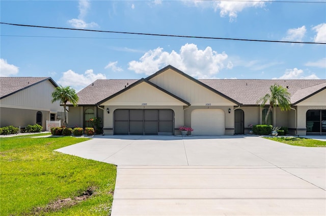 ranch-style house featuring a front yard and a garage