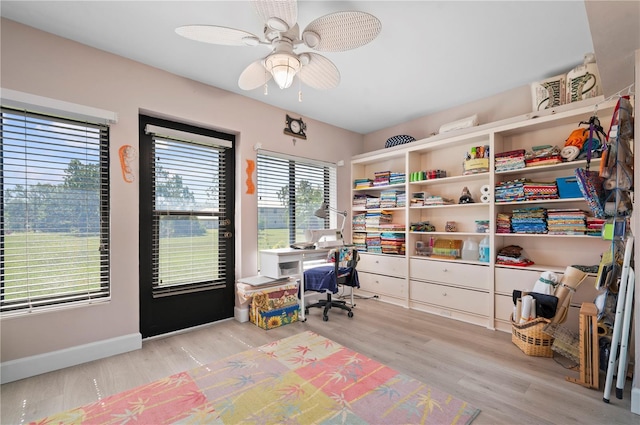 home office featuring ceiling fan and light hardwood / wood-style flooring