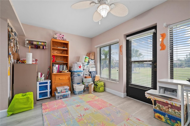 recreation room featuring ceiling fan and light hardwood / wood-style flooring