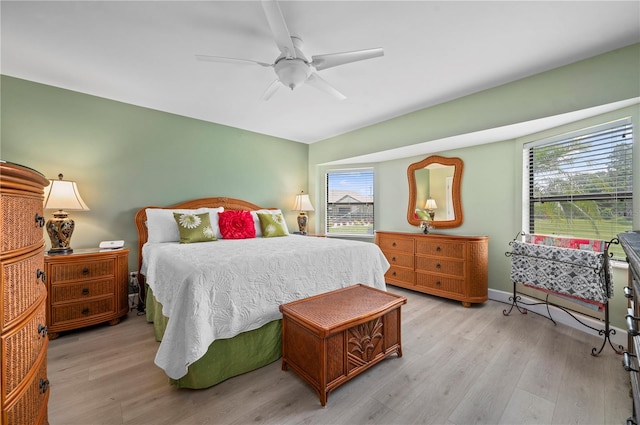 bedroom featuring multiple windows, ceiling fan, and light hardwood / wood-style floors