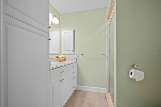 bathroom featuring vanity, a shower with shower door, and hardwood / wood-style flooring