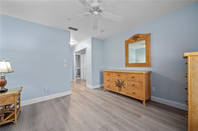 interior space with ceiling fan, light hardwood / wood-style floors, and a closet