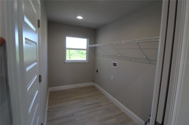 laundry room with light hardwood / wood-style flooring, washer hookup, and electric dryer hookup