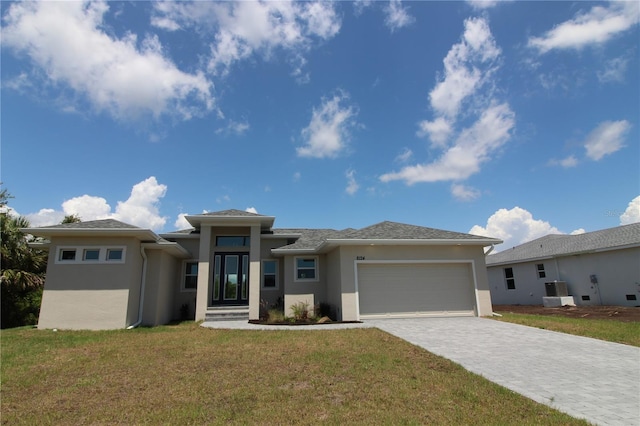 prairie-style house featuring a garage and a front yard