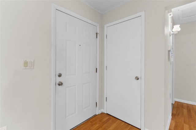 interior space with a textured ceiling and light wood-type flooring