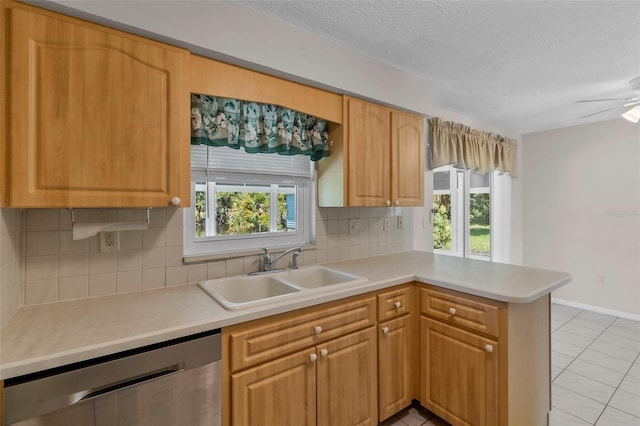 kitchen featuring backsplash, a wealth of natural light, sink, and stainless steel dishwasher