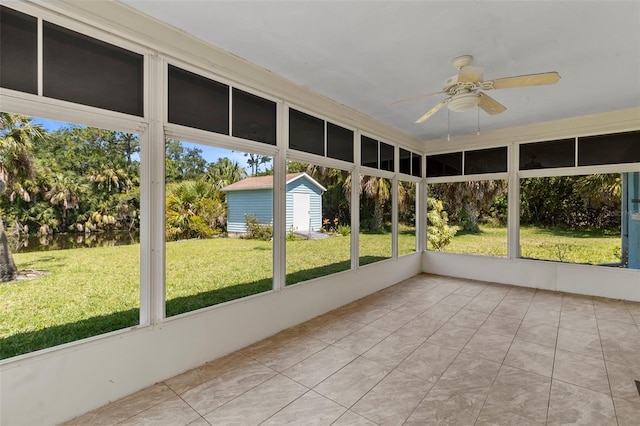 unfurnished sunroom with ceiling fan