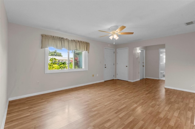 unfurnished room with ceiling fan, a textured ceiling, and light hardwood / wood-style flooring