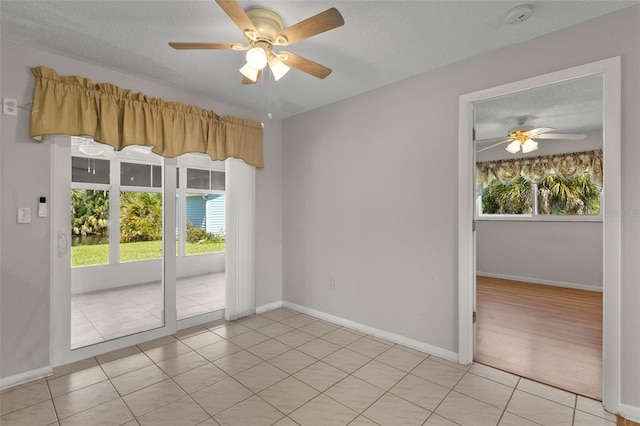 spare room with a textured ceiling, light hardwood / wood-style flooring, and ceiling fan