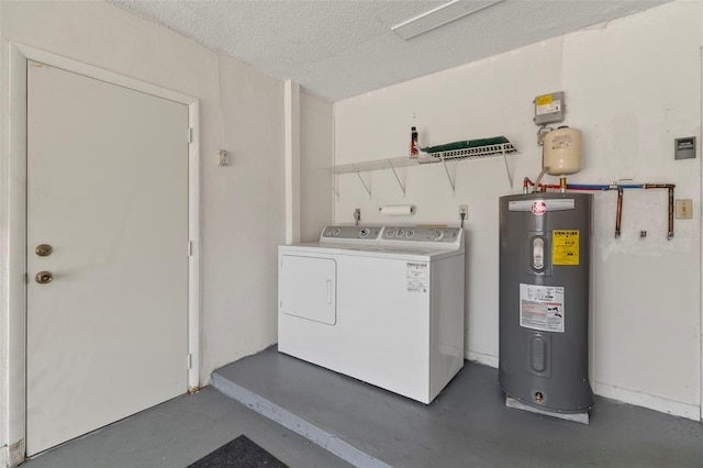 clothes washing area with electric water heater, washer and dryer, and a textured ceiling