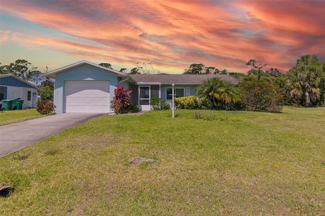 single story home with a garage and a lawn