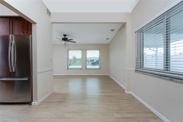 kitchen featuring stainless steel fridge, light wood-type flooring, and ceiling fan