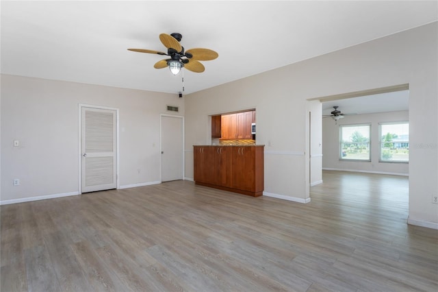 unfurnished living room with light hardwood / wood-style flooring and ceiling fan