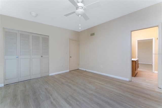 unfurnished bedroom with a closet, ceiling fan, and light hardwood / wood-style flooring