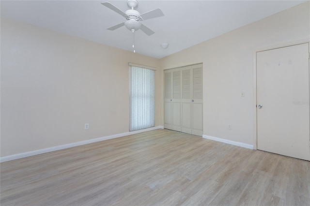 unfurnished bedroom featuring a closet, light hardwood / wood-style floors, and ceiling fan