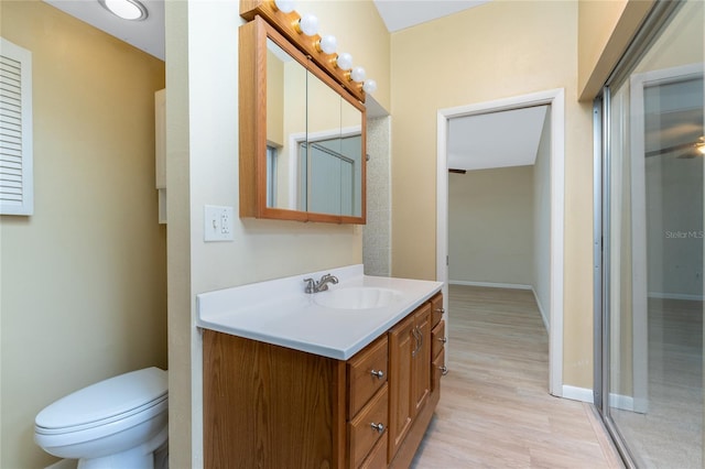 bathroom with vanity, hardwood / wood-style floors, and toilet